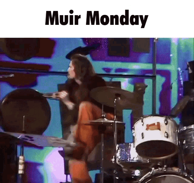 a man is playing drums with the words muir monday written above him