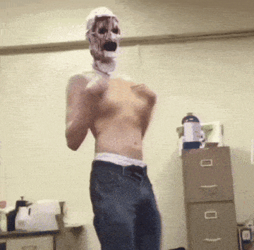 a shirtless man with a mask on his face is dancing
