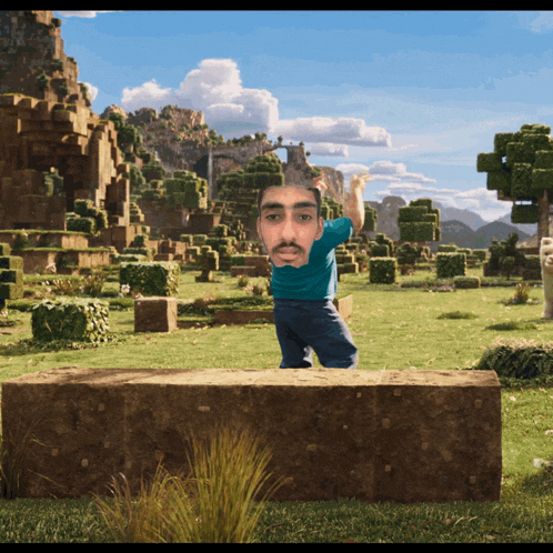 a man in a blue shirt is standing on a stone block in a minecraft world