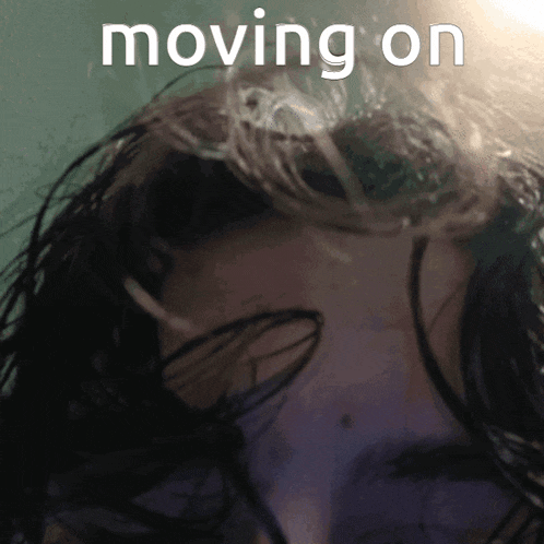 a close up of a person 's head with the words moving on above
