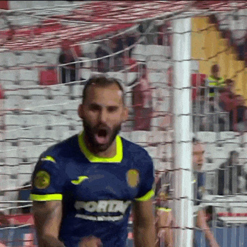 a soccer player wearing a blue and yellow jersey that says ' fortn ' on it