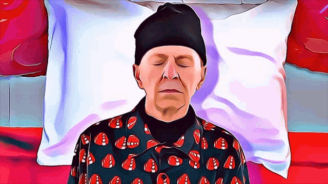 a man laying on a bed with his eyes closed wearing a black hat