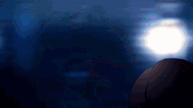a person in a dark room with a light in the background