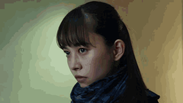 a woman wearing a blue scarf around her neck