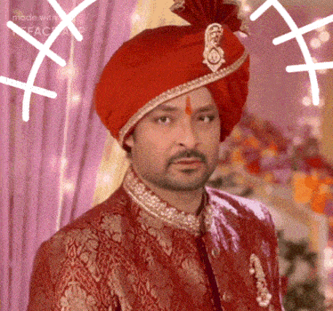 a man wearing a red turban and a red jacket is being made with facecam