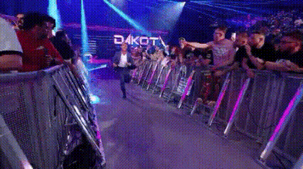 a crowd of people are standing in front of a stage with the word dakota on it