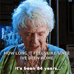 an elderly woman is crying with a caption that says `` how long it feels like since i 've been home '' .