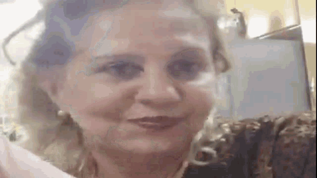 a close up of a woman 's face while sitting on a couch .