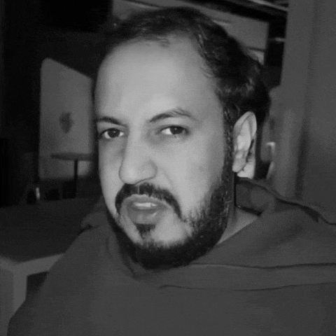 a man with a beard is wearing a red hoodie