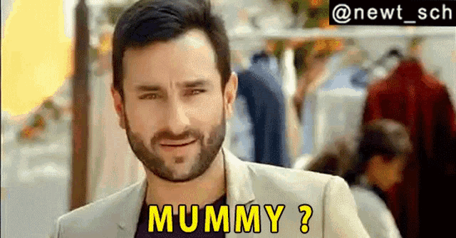 a man with a beard is smiling and says mummy