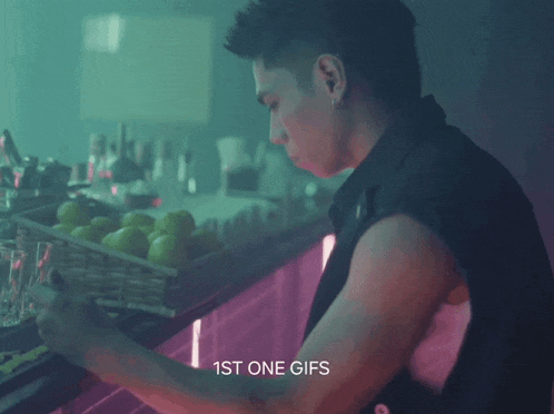 a man standing in front of a counter with the words 1st one gifs on the bottom