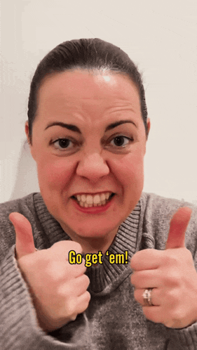 a woman is giving a thumbs up with the words go get em written below her