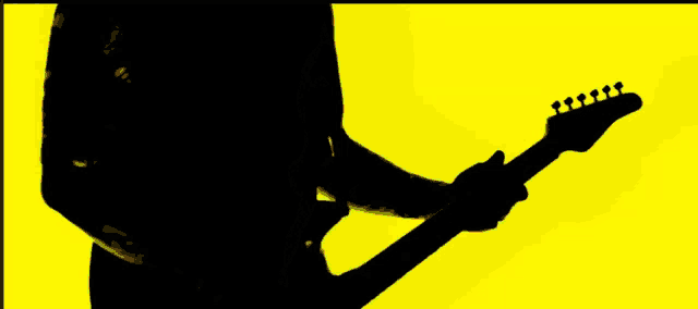 a silhouette of a person playing a guitar with a yellow background