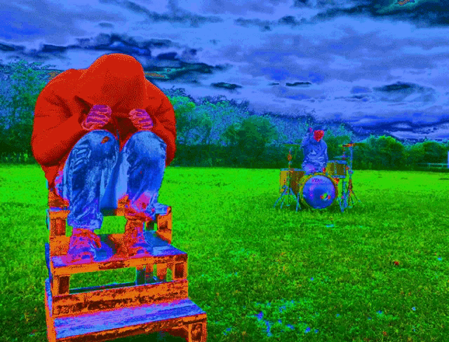 a colorful painting of a person sitting on a chair in a field with a drummer in the background