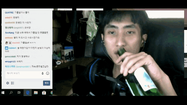 a man drinking from a bottle while watching a video on twitch