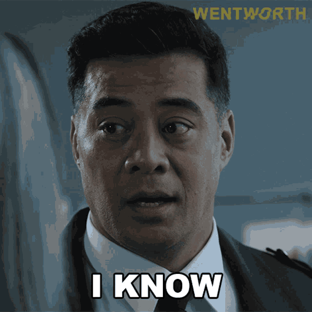 a man in a suit and tie says i know in front of a wentworth logo