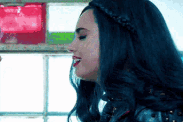 a close up of a woman 's face with blue hair and red lips .