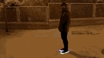 a person wearing glow in the dark shoes is standing in the snow