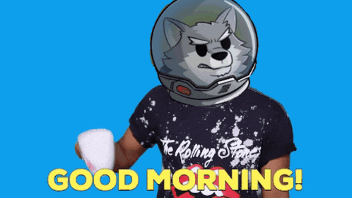 a man wearing a rolling stones shirt is holding a cup