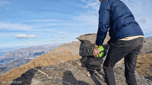 a person standing on top of a mountain with the words holy ridiculous in the corner