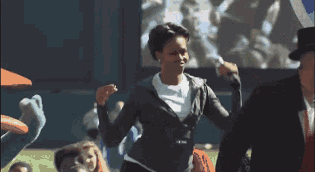 michelle obama throws a baseball to a child