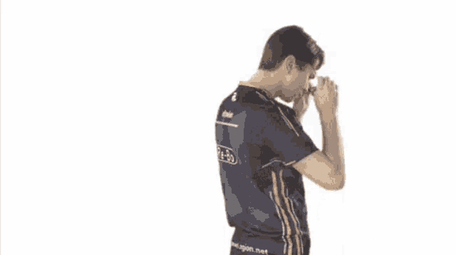 a man wearing a blue shirt and sunglasses is dancing .