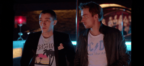 two men are standing next to each other and one of them is wearing a t-shirt that says c/d