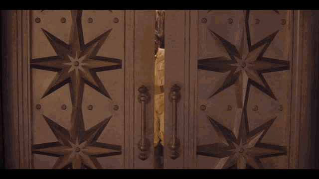 a group of men in military uniforms stand in a doorway
