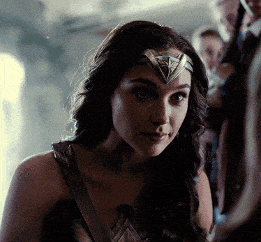a close up of a woman wearing a headband with a triangle on it