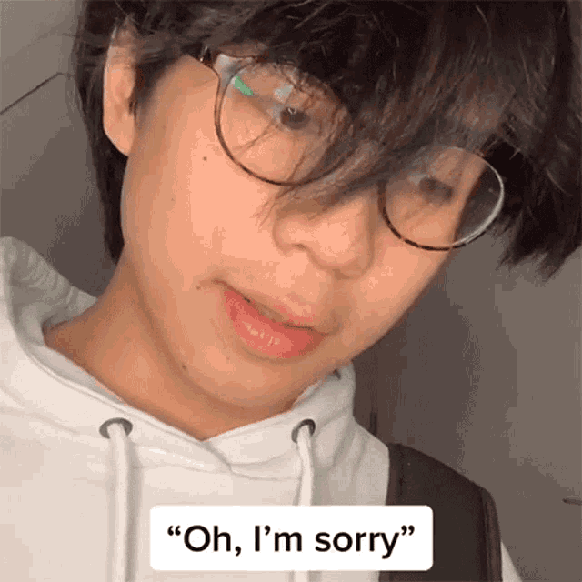 a person wearing glasses and a white hoodie says " oh i 'm sorry "