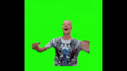 a man in a t-shirt with wings on it is standing on a green screen .