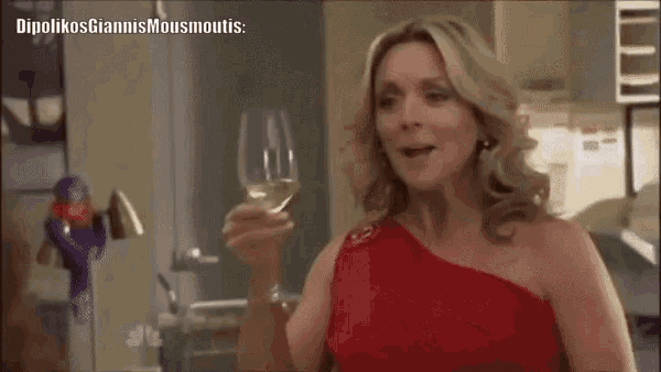 a woman in a red dress is holding a wine glass and saying i 'm so mad at you .