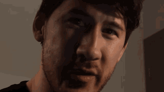 a man with a beard is smiling with his mouth open