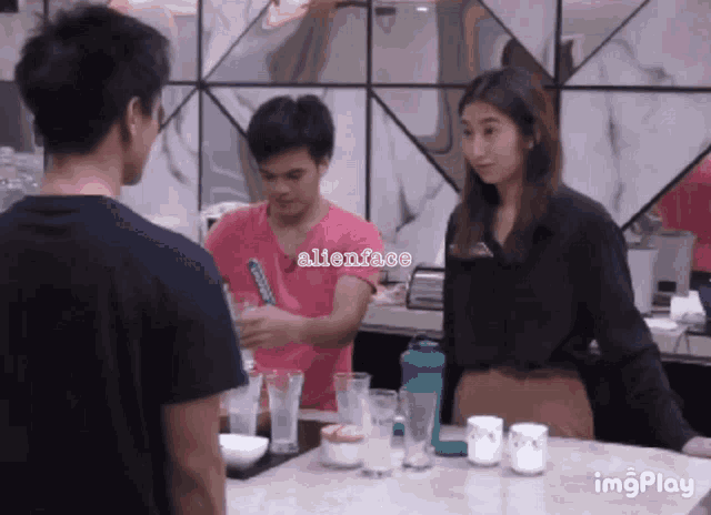 a man in a pink shirt with alienface on it