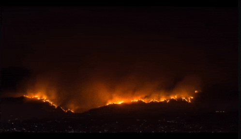 a large fire burning in the night sky