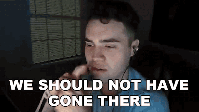 a man talking on a phone with the words " we should not have gone there " behind him
