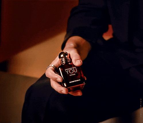 a man holding a bottle of stronger with you