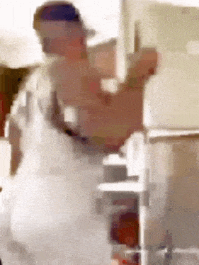 a blurry picture of a man standing next to a staircase .