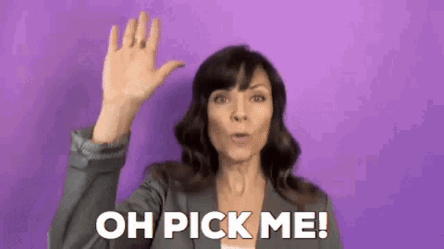 a woman is waving her hand in front of a purple background and saying `` oh pick me '' .