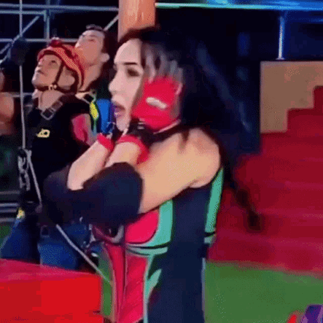 a woman in a colorful outfit is dancing on a stage .
