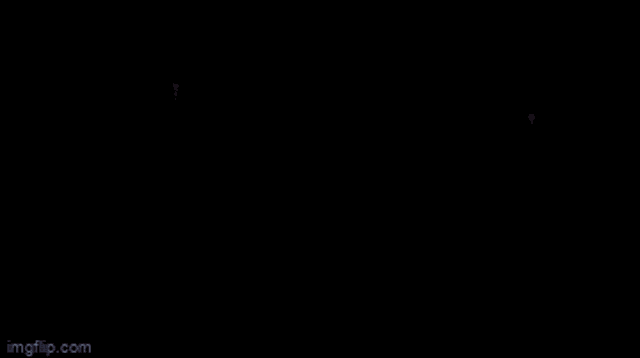 a video game character is standing in a dark room with glowing wings .