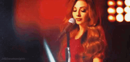 a woman is singing into a microphone in a pixel art .