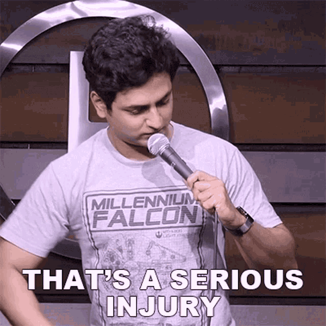 a man in a millennium falcon shirt is holding a microphone and says that 's a serious injury .