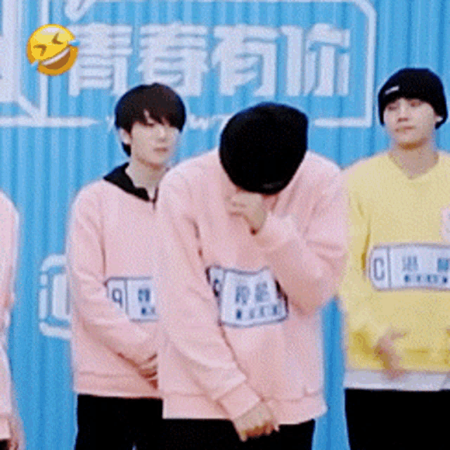 a group of young men wearing pink sweaters and yellow sweaters