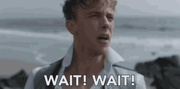a man standing on a beach with the words wait wait