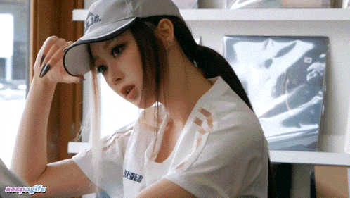 a woman wearing a hat and a shirt that says ycser on it