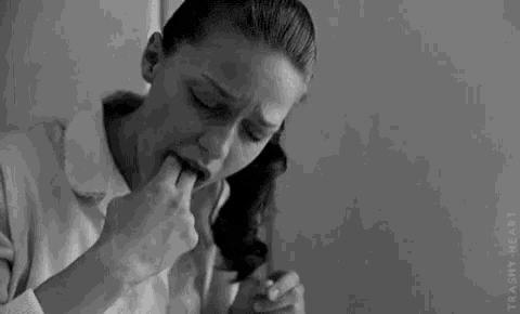 a woman is licking her lips while talking on a phone .