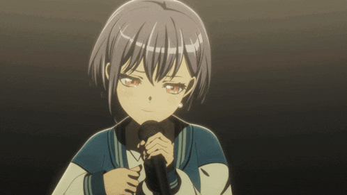 a girl with short hair is holding a microphone in her hands