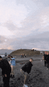 a group of people are posing for a picture on a hillside