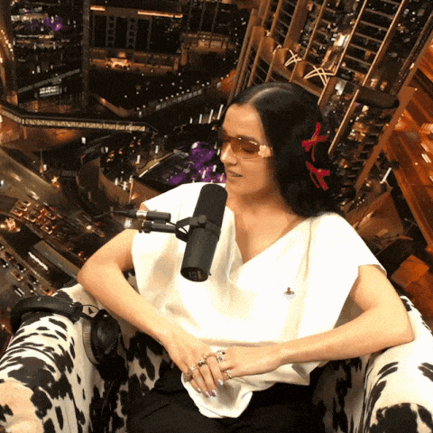 a woman sitting in a chair with a microphone in front of her